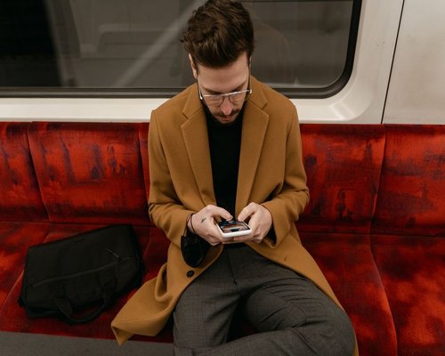Commuter using a smartphone on public transport