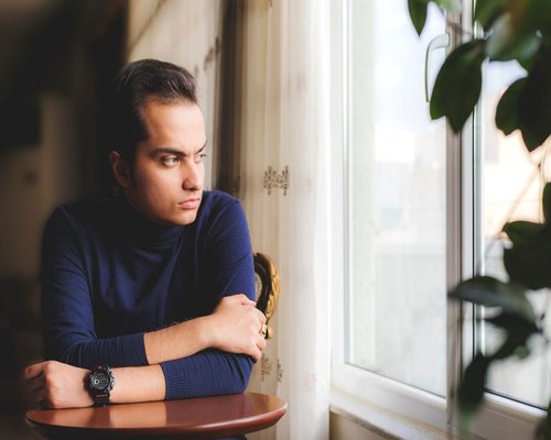Person looking out of a window thoughtfully