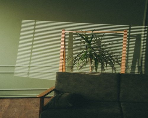 Sunlight streaming through living room blinds